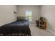 Bedroom with a dark bed frame, desk, and a window offering natural light and a view of the outdoors at 8840 Forester Ln, Apex, NC 27539