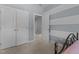 Cozy bedroom featuring striped accent walls, closet and hallway access, and neutral carpet at 8840 Forester Ln, Apex, NC 27539