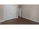 Comfortable bedroom with hardwood floors, a large closet, and neutral paint at 8840 Forester Ln, Apex, NC 27539