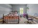 Charming bedroom with pastel walls, a wrought iron bed frame, and cozy decor accents at 8840 Forester Ln, Apex, NC 27539