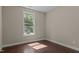 Cozy bedroom with hardwood flooring, neutral walls, and a large window at 8840 Forester Ln, Apex, NC 27539