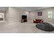A spacious bonus room with carpet flooring, neutral walls, and a TV area for relaxation and entertainment at 8840 Forester Ln, Apex, NC 27539