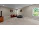 Spacious bonus room with carpet flooring, neutral walls, and ample natural light from multiple windows at 8840 Forester Ln, Apex, NC 27539