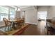 Sunlit dining room with hardwood floors and classic chandelier, seamlessly connected to other living areas at 8840 Forester Ln, Apex, NC 27539