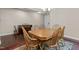 Bright dining room featuring a wooden table with seating for six and elegant chandelier at 8840 Forester Ln, Apex, NC 27539