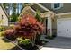 Charming home featuring stone accents, well-kept lawn, and a professionally landscaped front yard at 8840 Forester Ln, Apex, NC 27539