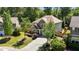 Beautiful exterior elevation with stone accents, lush landscaping, and an inviting driveway entrance at 8840 Forester Ln, Apex, NC 27539
