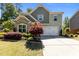 Charming two-story home featuring manicured landscaping and a two-car garage, offering curb appeal at 8840 Forester Ln, Apex, NC 27539
