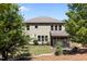Back exterior of a two-story home with a well-maintained lawn and a screened-in porch at 8840 Forester Ln, Apex, NC 27539