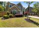Attractive two-story home featuring stone accents, well-kept lawn, and professional landscaping at 8840 Forester Ln, Apex, NC 27539