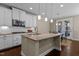 Spacious kitchen with center island, granite countertops, stainless appliances, and pendant lighting at 8840 Forester Ln, Apex, NC 27539