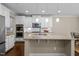 Open concept kitchen featuring a center island with a granite countertop, and stainless steel appliances at 8840 Forester Ln, Apex, NC 27539
