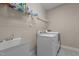 A functional laundry room featuring a washing machine, dryer, and a utility sink for added convenience at 8840 Forester Ln, Apex, NC 27539