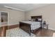 Spacious main bedroom featuring hardwood floors, a tray ceiling, and neutral decor at 8840 Forester Ln, Apex, NC 27539
