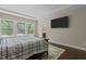 Relaxing main bedroom with hardwood flooring, tray ceiling, and ample sunlight from large windows at 8840 Forester Ln, Apex, NC 27539