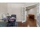 Home office with hardwood floors, natural light, and access to adjacent rooms at 8840 Forester Ln, Apex, NC 27539
