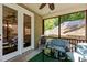 Relaxing screened patio with comfortable seating, a ceiling fan, and views of the landscaped backyard at 8840 Forester Ln, Apex, NC 27539