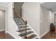 Elegant staircase with dark wood railings and white risers adds charm to the home's interior at 8840 Forester Ln, Apex, NC 27539