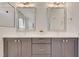 Bathroom featuring dual sinks, grey cabinets with gold accents and modern fixtures at 100 Highveld Ave, Chapel Hill, NC 27516