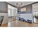Upstairs bonus room with hardwood floors, gray accent wall, and wrought iron railing at 100 Highveld Ave, Chapel Hill, NC 27516