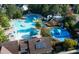 Aerial view of the community pool, water slide, splashpad, and sun umbrellas at 100 Highveld Ave, Chapel Hill, NC 27516
