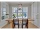 Bright dining room with large windows, wood table, and modern light fixture at 100 Highveld Ave, Chapel Hill, NC 27516