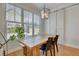 Dining room with large windows, wood table, modern light fixture, and barn door at 100 Highveld Ave, Chapel Hill, NC 27516