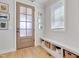 Inviting entryway features a wooden front door, a built-in bench with storage, and hardwood floors at 100 Highveld Ave, Chapel Hill, NC 27516