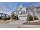 Two-story home with white siding, stone accents, a well-manicured lawn, and an attached two car garage at 100 Highveld Ave, Chapel Hill, NC 27516