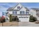 Beautiful two-story home with white siding, stone accents, well-manicured landscaping, and a two car garage at 100 Highveld Ave, Chapel Hill, NC 27516