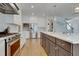 Bright kitchen with a large island, gas range, stainless steel appliances, and modern lighting at 100 Highveld Ave, Chapel Hill, NC 27516