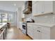 Updated kitchen with stainless steel appliances, gas range, and white cabinets at 100 Highveld Ave, Chapel Hill, NC 27516