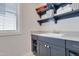Well-organized laundry room with a sink, plenty of storage, and natural light from a window at 100 Highveld Ave, Chapel Hill, NC 27516