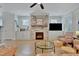Inviting living room with stone fireplace, hardwood floors, and plenty of natural light at 100 Highveld Ave, Chapel Hill, NC 27516