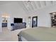 Primary bedroom exhibiting vaulted ceilings and ensuite bathroom and closet entrances at 100 Highveld Ave, Chapel Hill, NC 27516