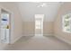 View of attic space with neutral walls, carpeted floors and light-filled window at 10320 Crisp Dr, Raleigh, NC 27614