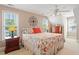 Bright bedroom featuring large windows, two nightstands, a dresser, and a patterned bed at 10320 Crisp Dr, Raleigh, NC 27614