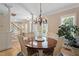 Dining area with chandelier, round table with seating for four, and hardwood flooring at 10320 Crisp Dr, Raleigh, NC 27614