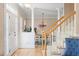 Bright foyer with hardwood floors, staircase, and view into the dining area at 10320 Crisp Dr, Raleigh, NC 27614