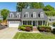 Charming two-story home with a well-manicured lawn, attached garage, and welcoming front porch at 10320 Crisp Dr, Raleigh, NC 27614
