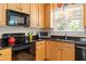 Close-up view of the kitchen with black countertops, a sink, and stainless steel appliances at 10320 Crisp Dr, Raleigh, NC 27614