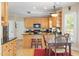 Charming kitchen featuring wooden cabinets, black countertops, stainless appliances and eat-in dining table and chairs at 10320 Crisp Dr, Raleigh, NC 27614