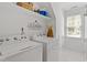 Bright laundry room with washer, dryer, storage shelf and laundry themed wall decor at 10320 Crisp Dr, Raleigh, NC 27614