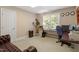 Bright office space with a desk, chair, shelving, and a comfortable leather couch at 10320 Crisp Dr, Raleigh, NC 27614