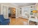 Bright office area with built-in shelving, French doors, and comfortable seating at 10320 Crisp Dr, Raleigh, NC 27614