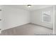 Bright bedroom with a neutral color palette, carpet flooring, and a window for natural light at 105 S Mule Way # 89, Benson, NC 27504