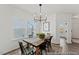 Dining room featuring a rustic table with a modern chandelier and views to the outdoors through large windows at 105 S Mule Way # 89, Benson, NC 27504