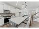 Bright kitchen featuring a center island, pendant lighting, stainless appliances and views to the living room and stairs at 105 S Mule Way # 89, Benson, NC 27504