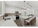 Bright kitchen featuring a center island, pendant lighting, stainless appliances and views to the dining room at 105 S Mule Way # 89, Benson, NC 27504