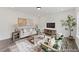 Cozy living room featuring neutral furniture, wood accents, an area rug, and an abundance of natural light at 105 S Mule Way # 89, Benson, NC 27504